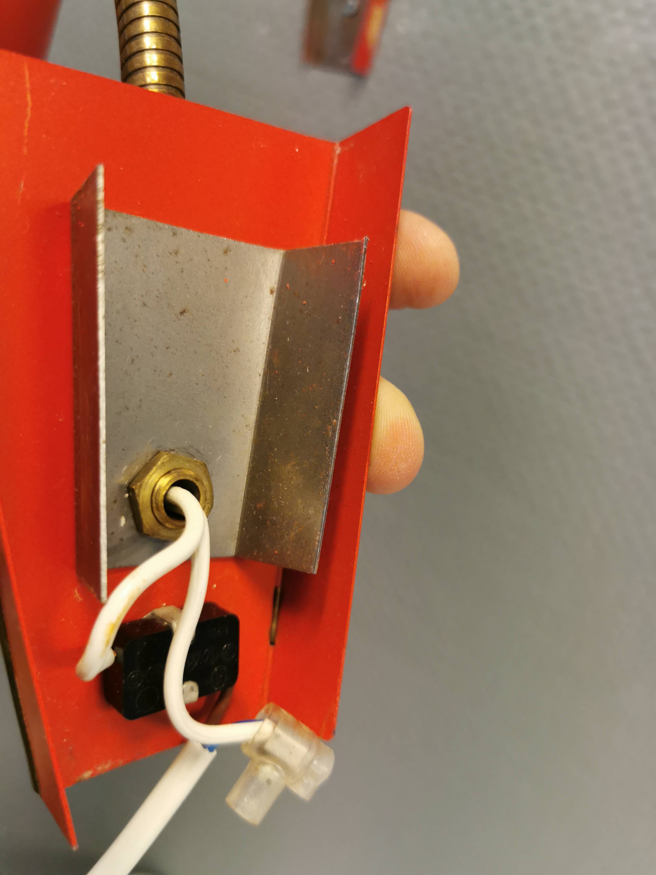 Danish red lacquered wall light with brass details. Estimated 1980s