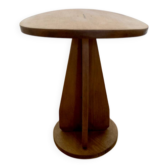 Wooden stool with a convex seat.