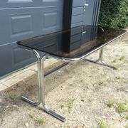 Dining table of the 70s in smoked glass and chromed metal