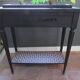 Vintage planter on wheels made of oak, repainted in black.