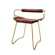 Organic bar stool with a vintage brass backrest and brown leather.