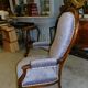 Relaxed Voltaire armchair with walnut racks