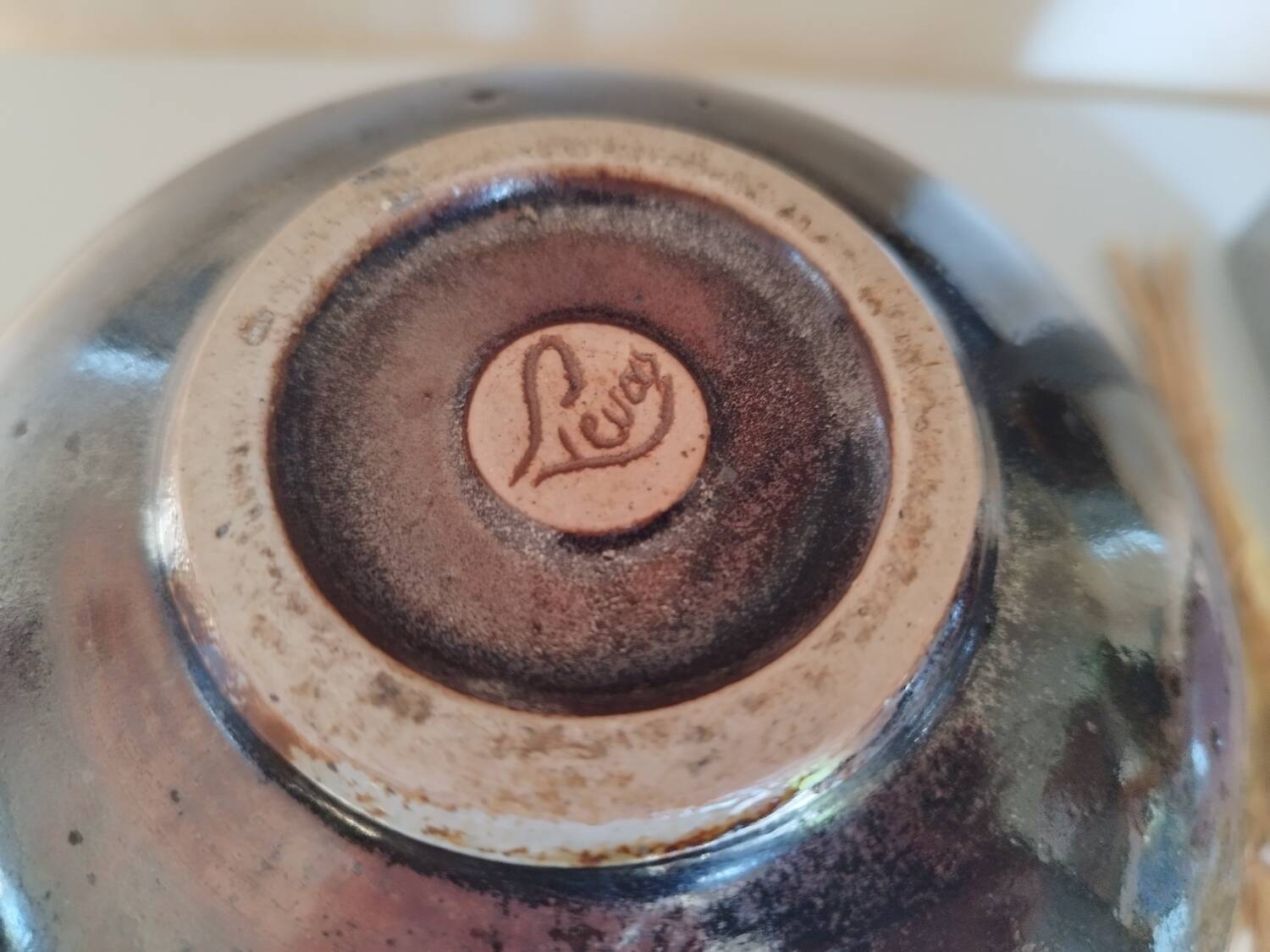 Stoneware pitcher by Matthieu Liévois in shades of red