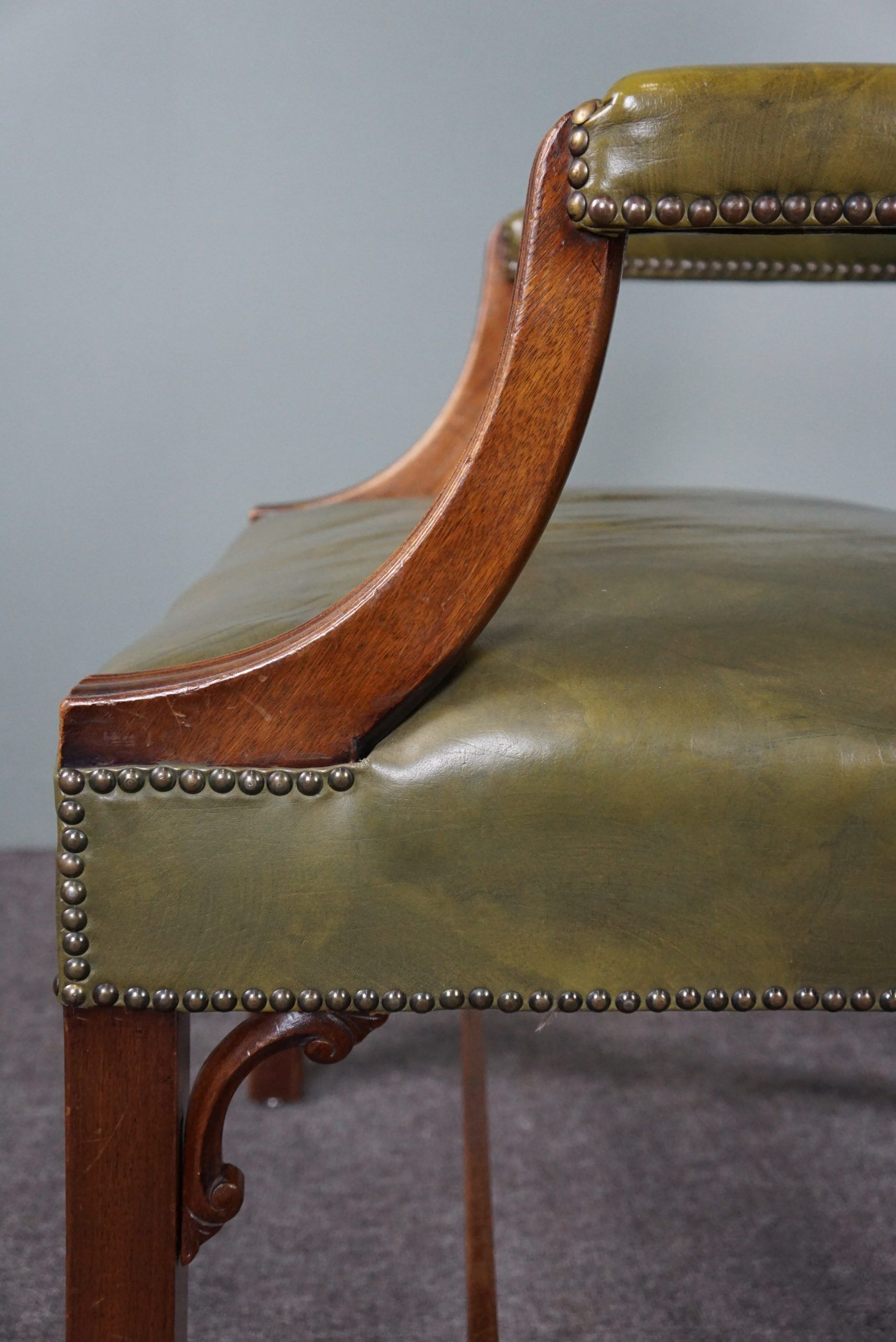Elegant armchair and footrest in English green leather