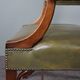 Elegant armchair and footrest in English green leather