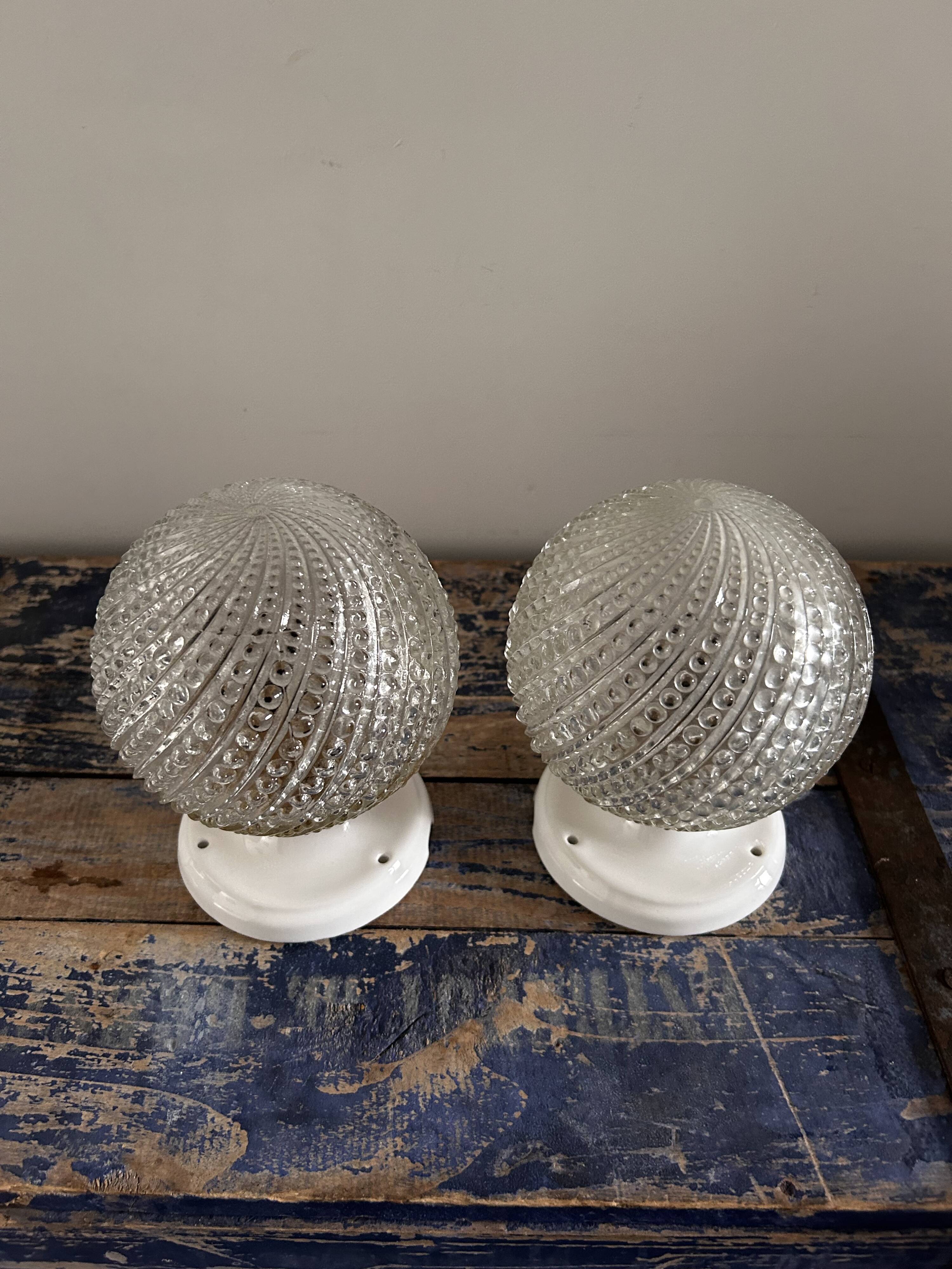 Set of two chiseled glass globe wall lights