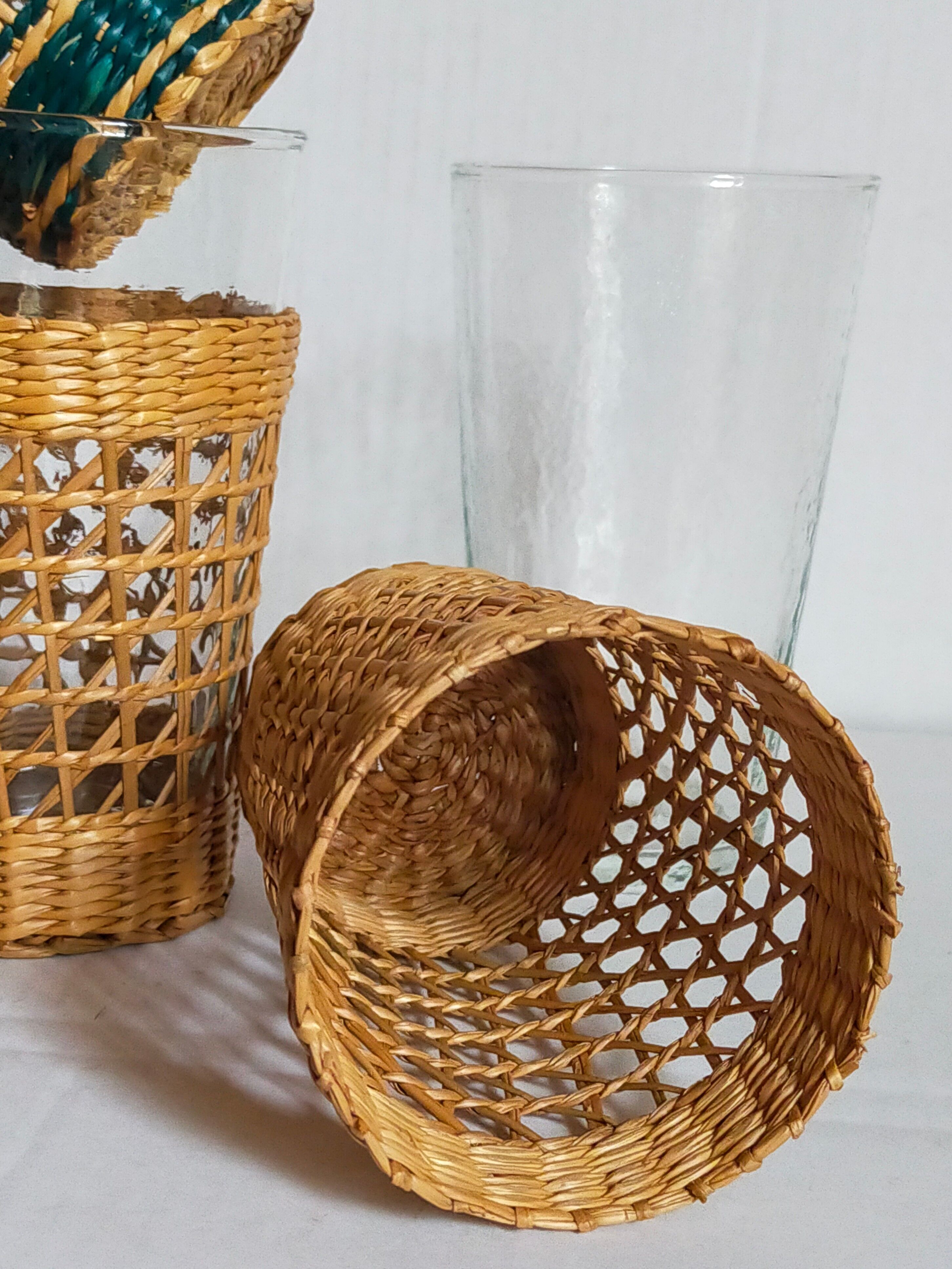 Four long drink glasses in vintage woven rattan cases