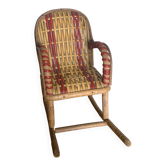 Antique miniature rocking chair in rattan for dolls.