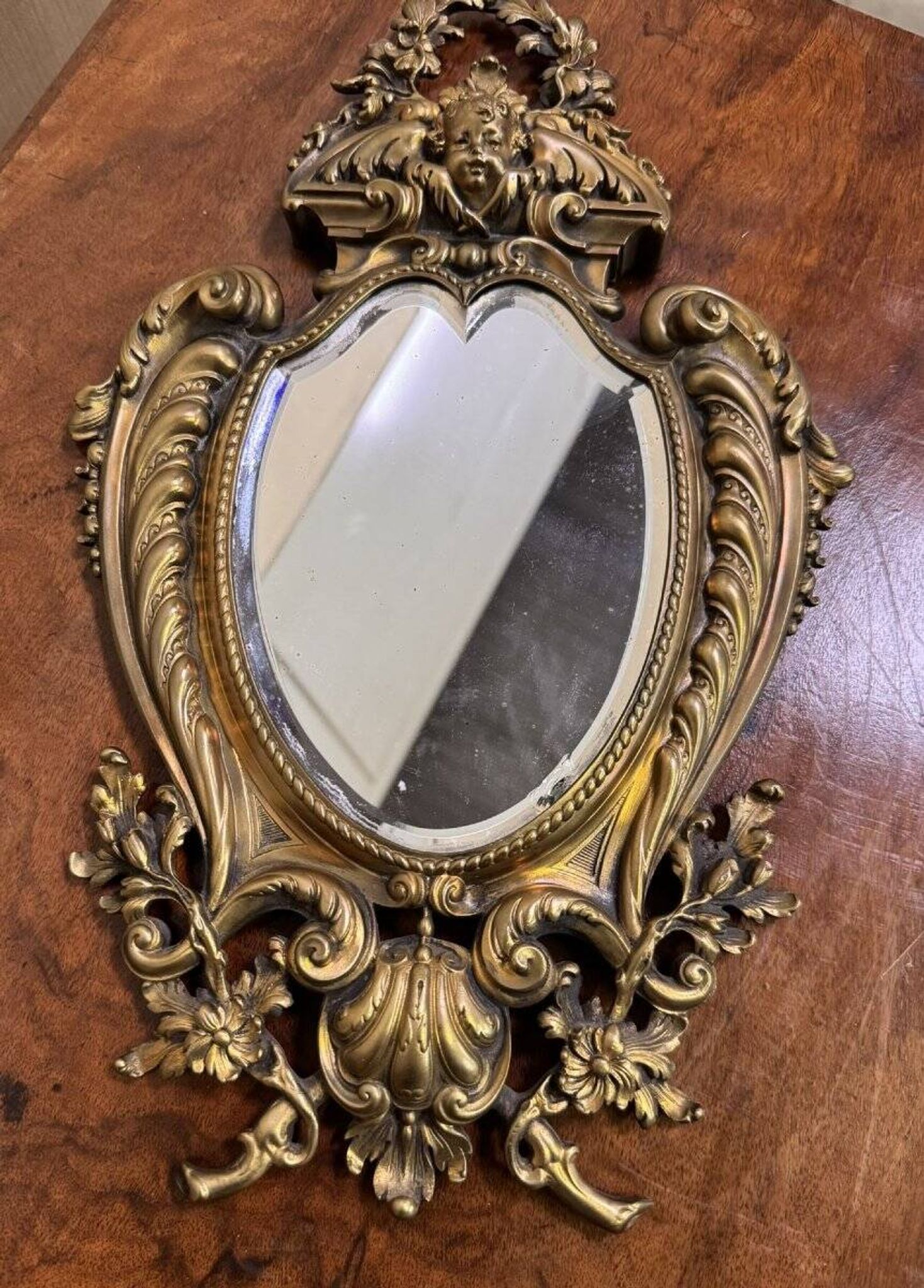 Mirror in the Louis XV Rocaille style in gilded bronze.