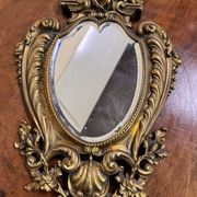 Mirror in the Louis XV Rocaille style in gilded bronze.