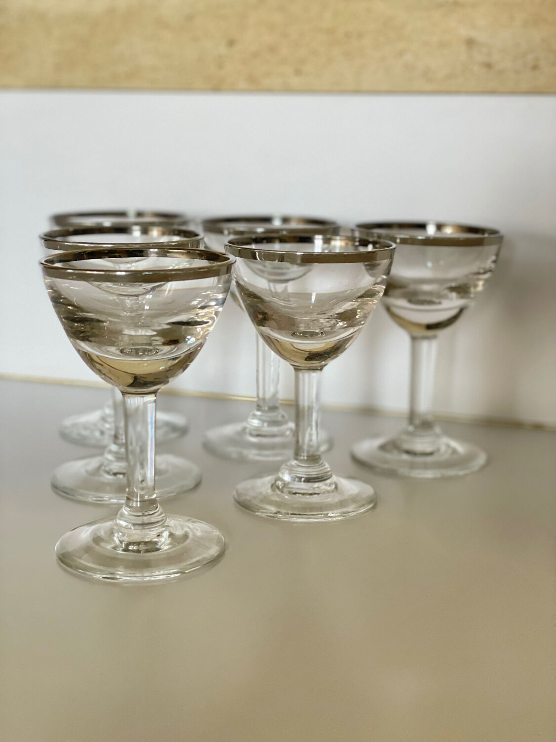 Set of 8 stemmed port glasses with silver trim.