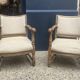 Pair of wooden and cream fabric armchairs