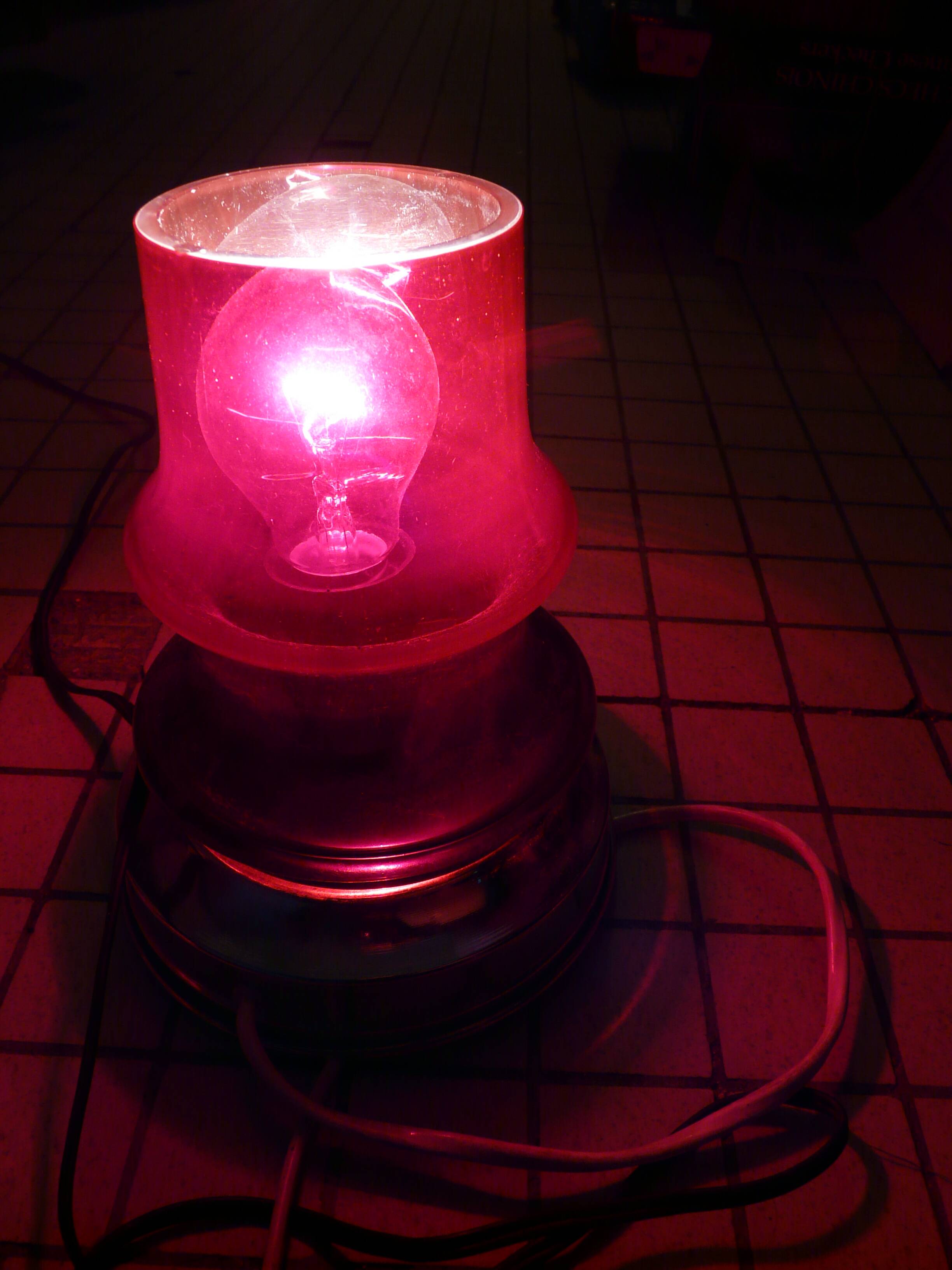 Red glass table lamp on a chrome base.