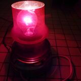 Red glass table lamp on a chrome base.