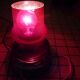 Red glass table lamp on a chrome base.