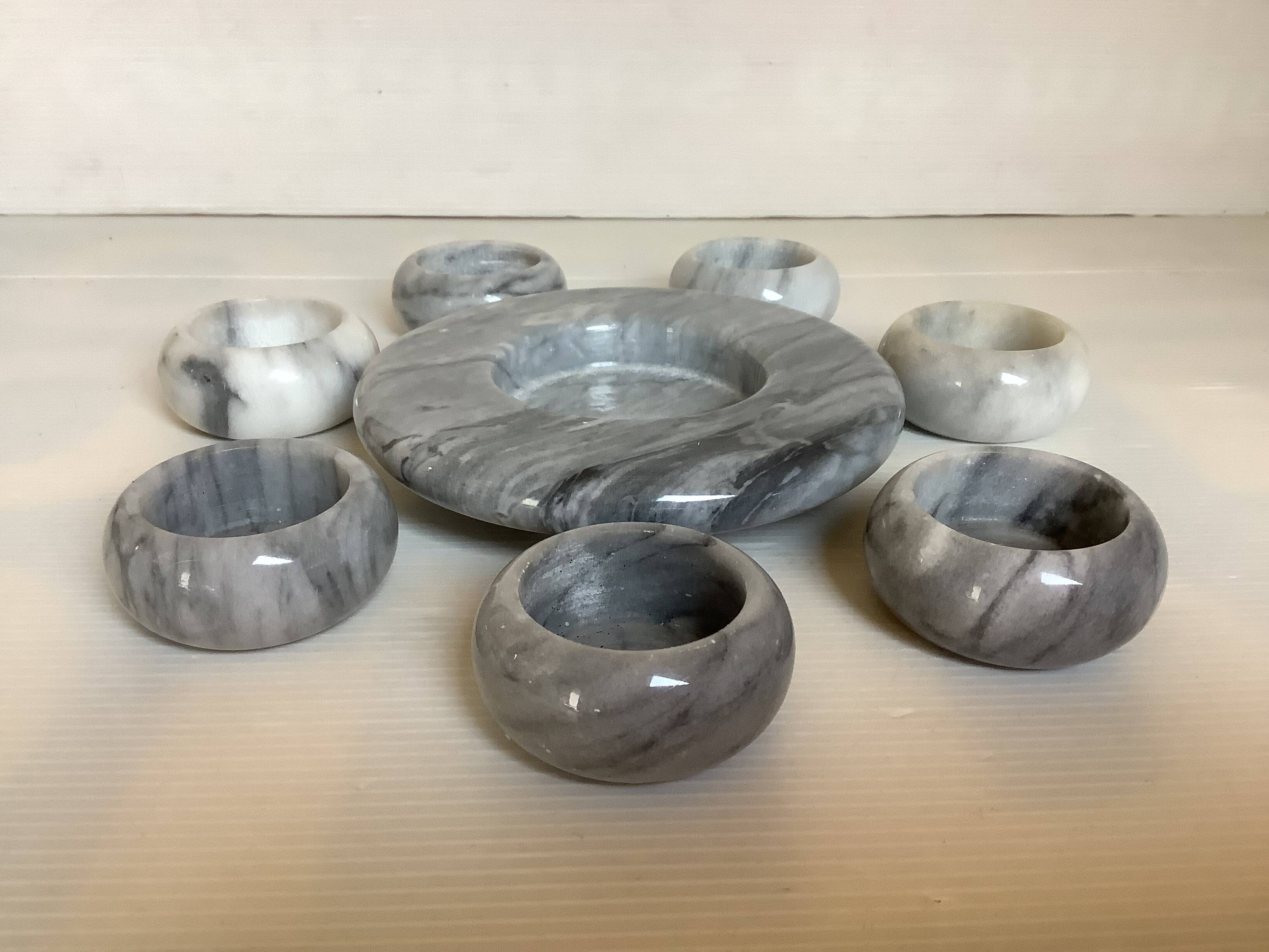 Eight grey-white marble candlesticks