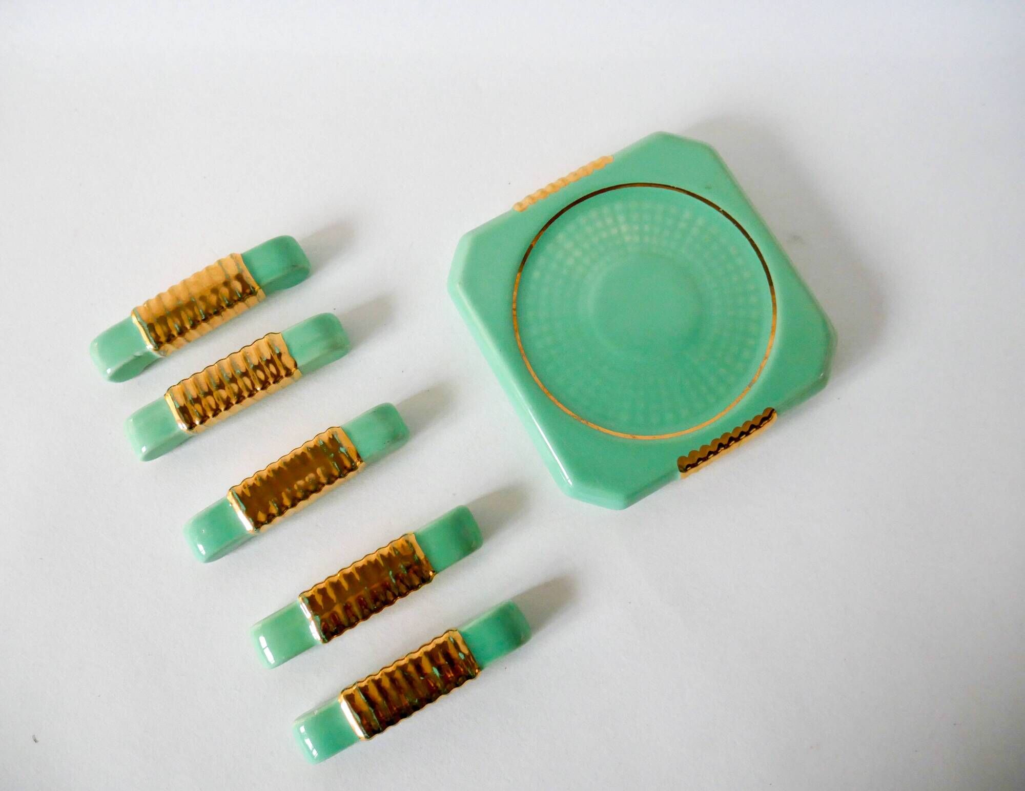 set of coasters and knife holders in mint green and gold art deco ceramic 1930