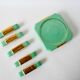 set of coasters and knife holders in mint green and gold art deco ceramic 1930