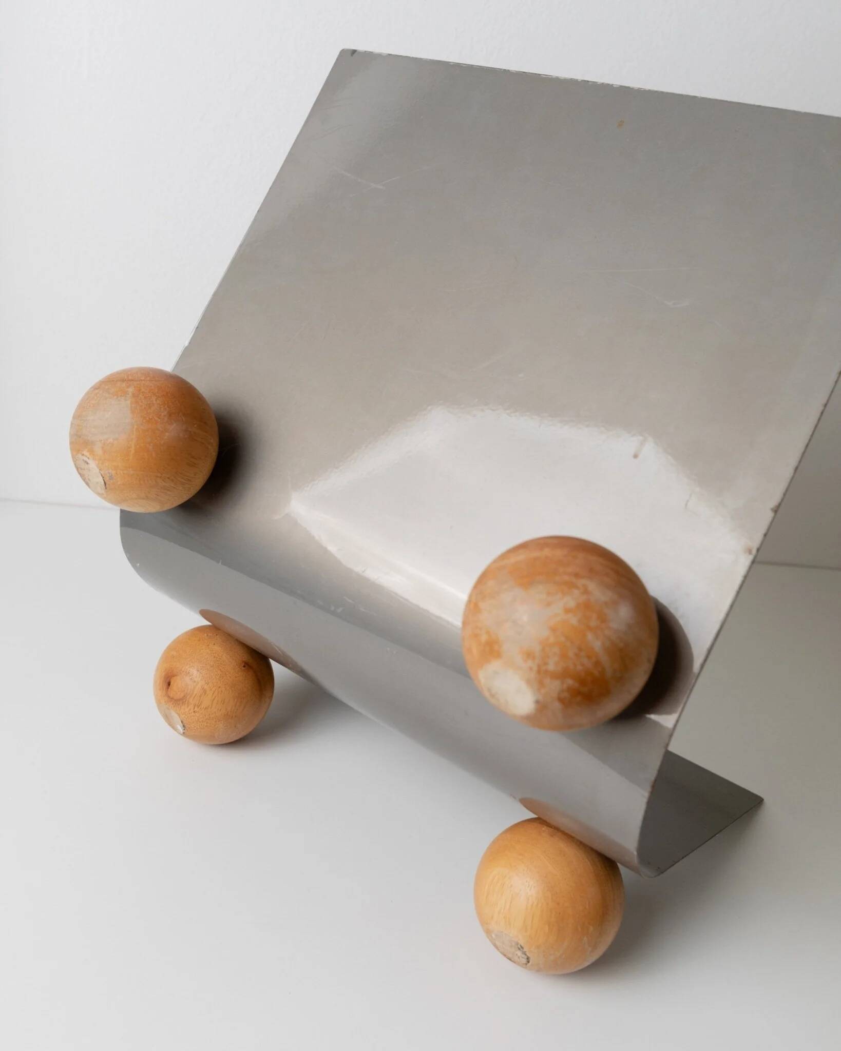 Silver metal magazine rack with wooden ball feet - Space Age 1980s retro storage