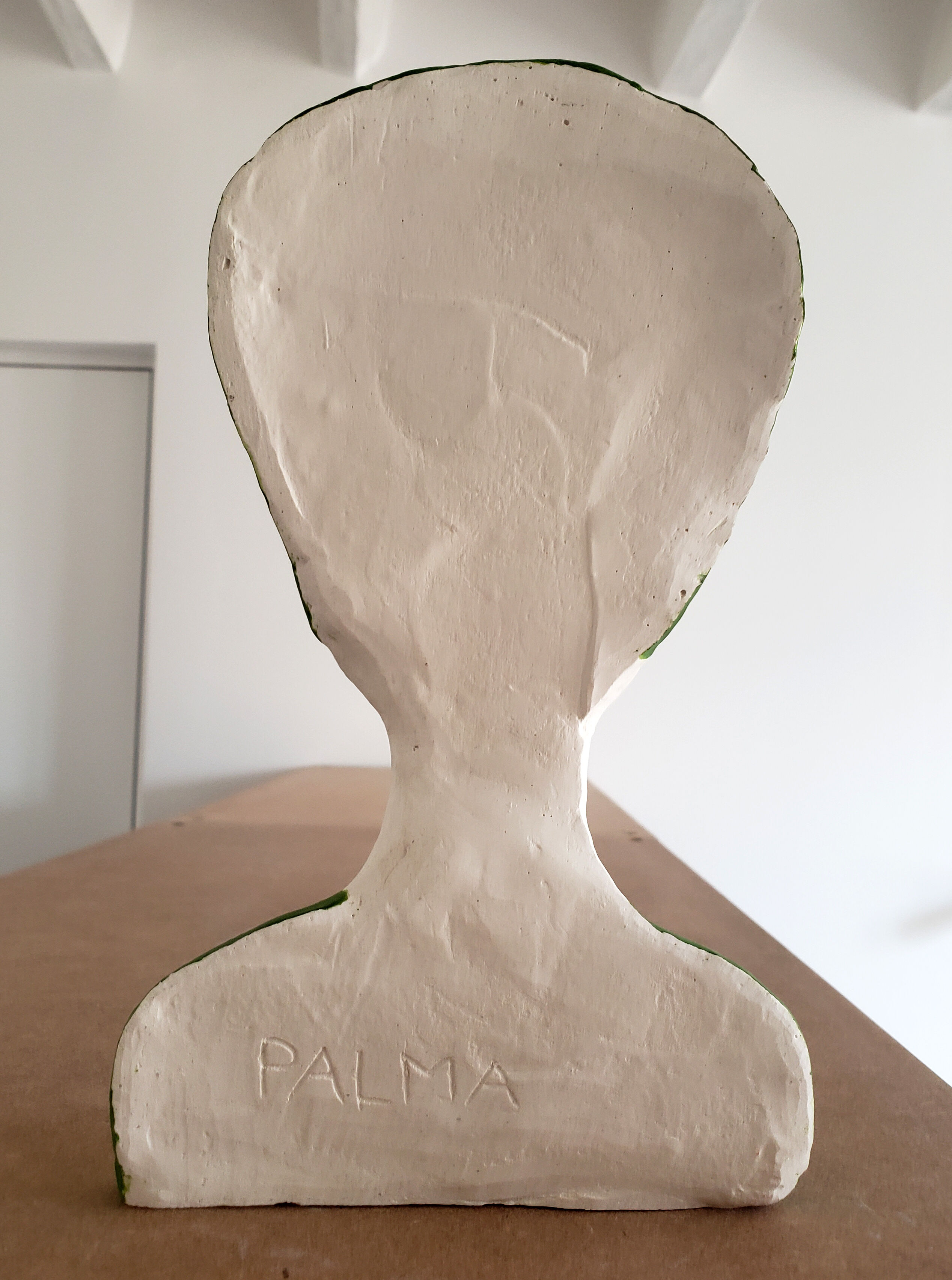 Bust of a woman in green and white plaster