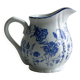 White porcelain milk jug with blue floral designs.