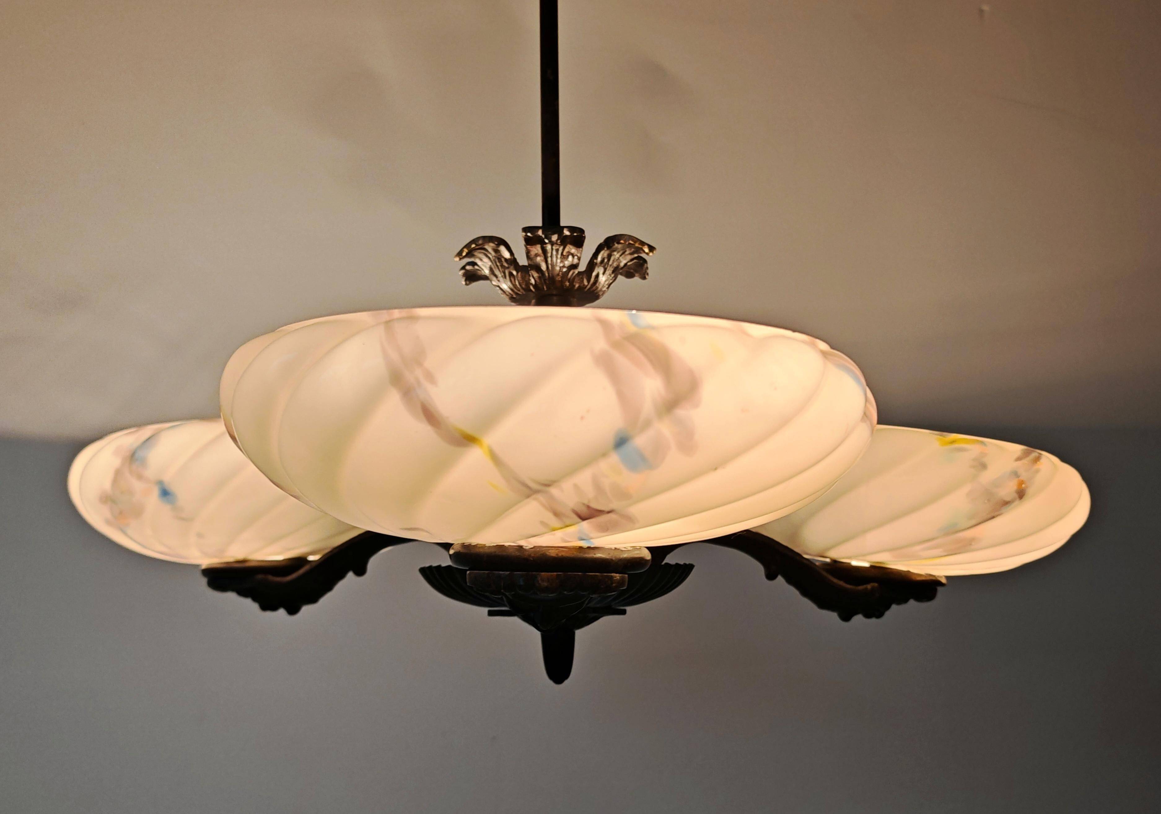 Art Deco bronze three-arm chandelier with marbled glass shades.
