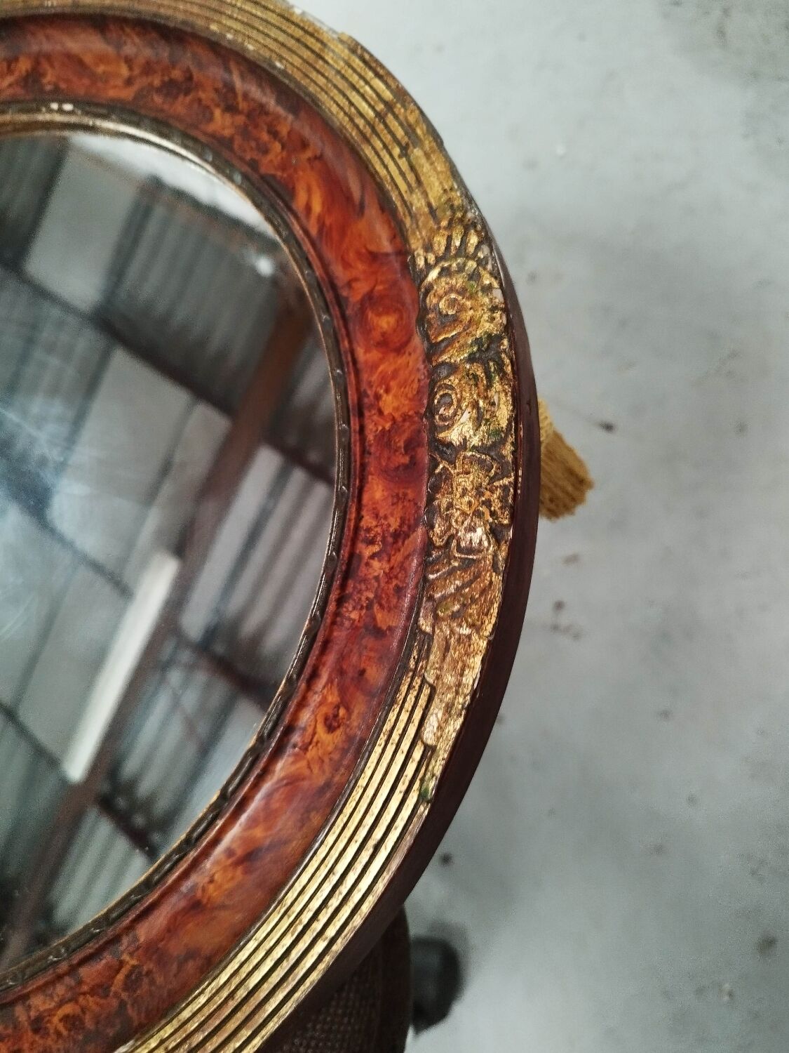 Golden oval art deco mirror