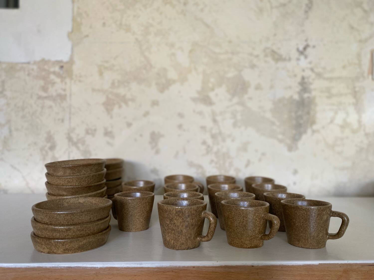 Set of stoneware coffee cups with saucers