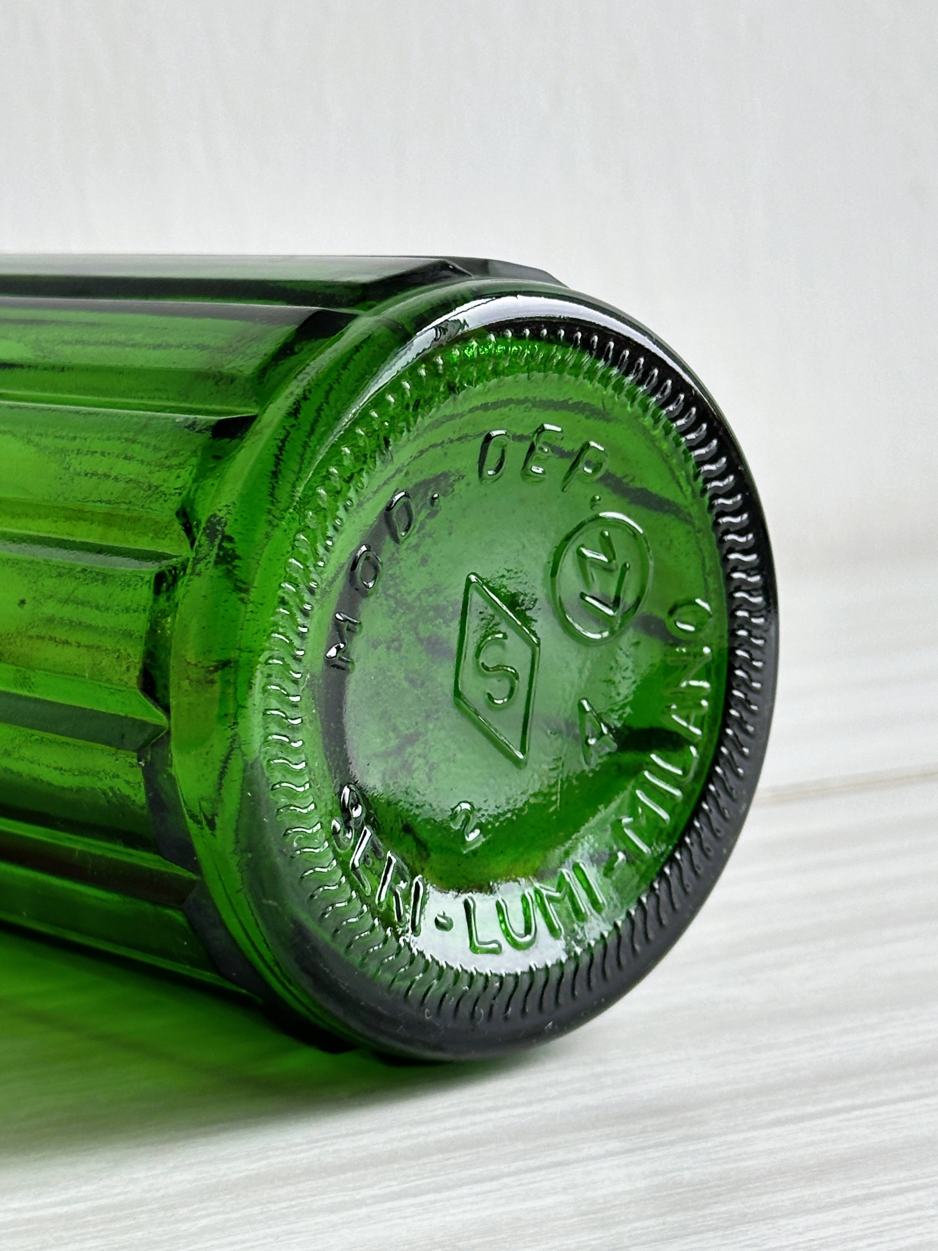 Green glass bottle, ribbed design.