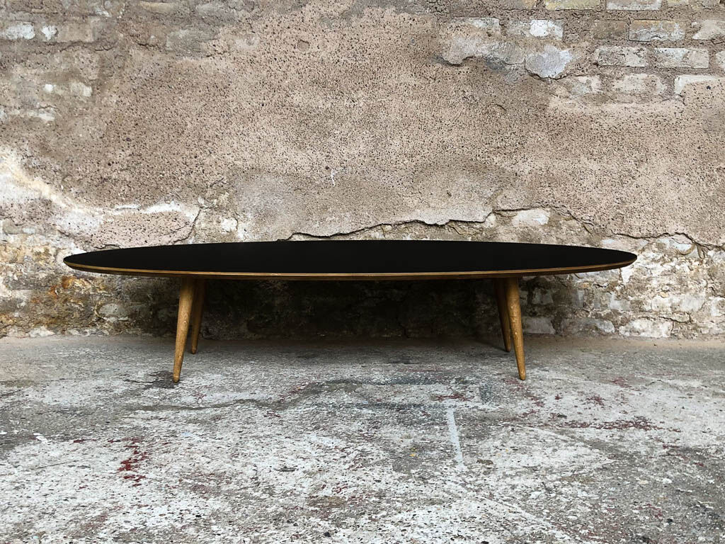 Oval coffee table with a black tray and oak-turned feet