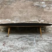 Oval coffee table with a black tray and oak-turned feet