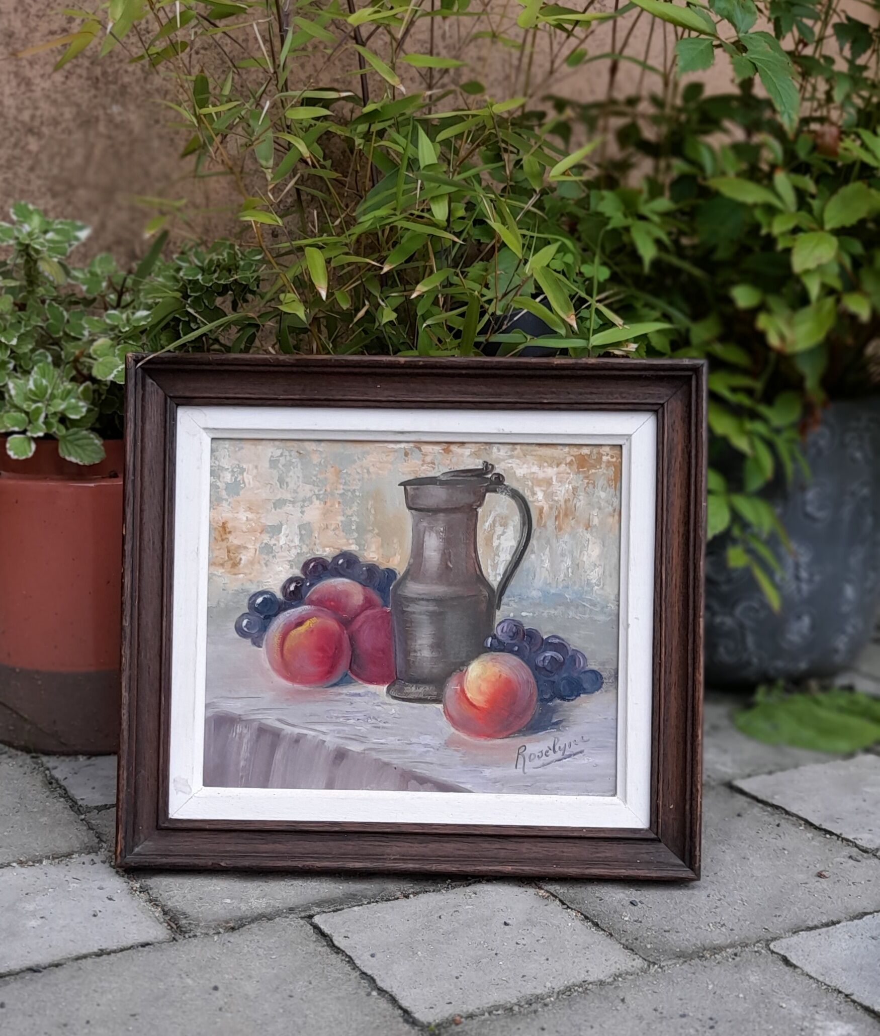 Still life painting with fruit, peach, bunch of grapes and tin pitcher, signed "roselyne"