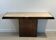 Console with a cannon-shaped travertine rifle stand. French work. Around 1970.