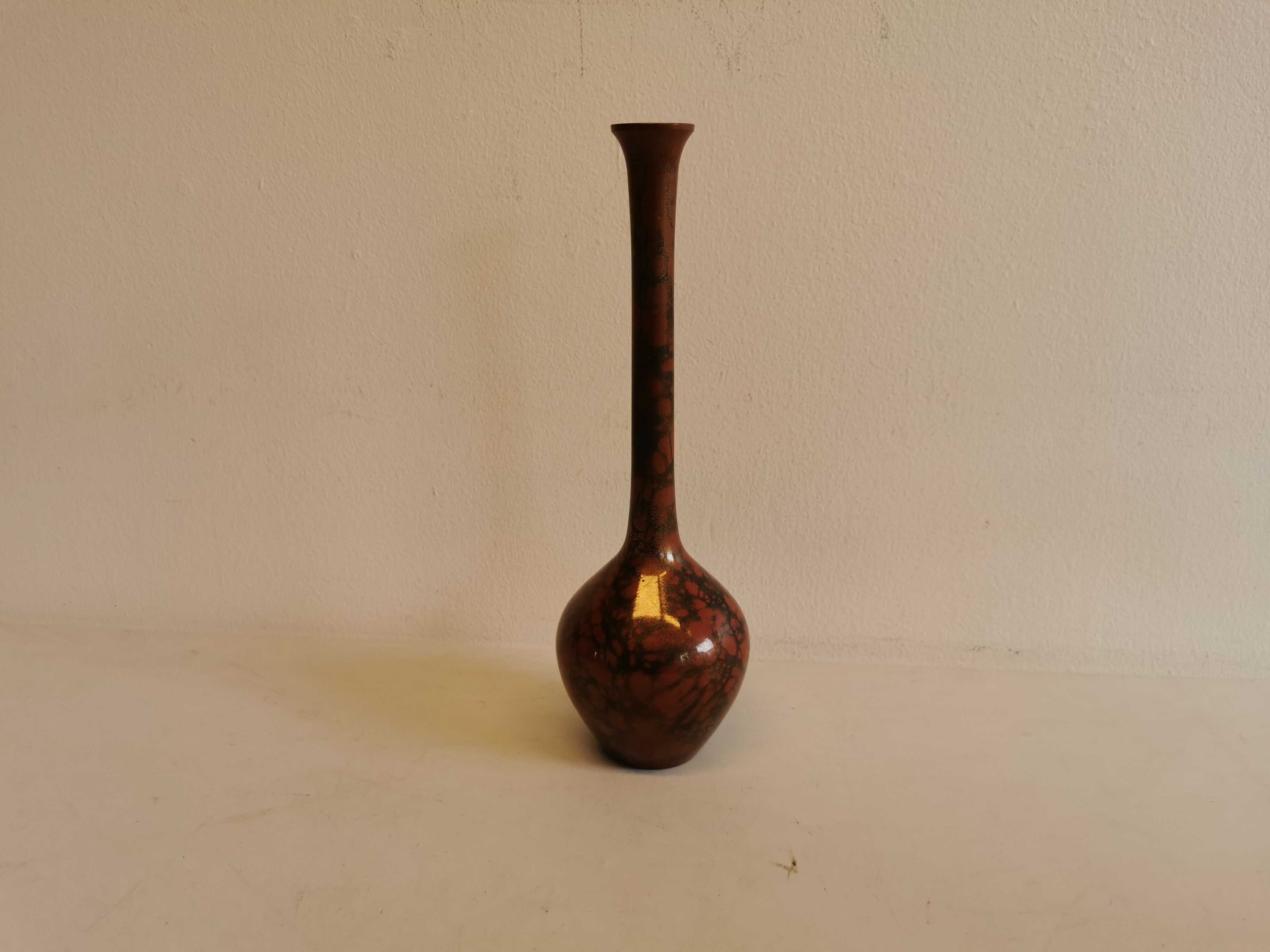 Slim vase with metallic finish.