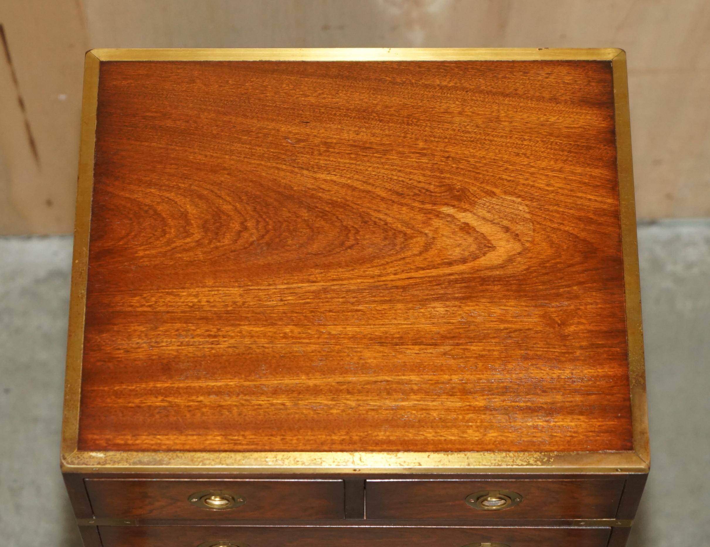 Pair of vintage military campaign high chests of drawers with leather tops.