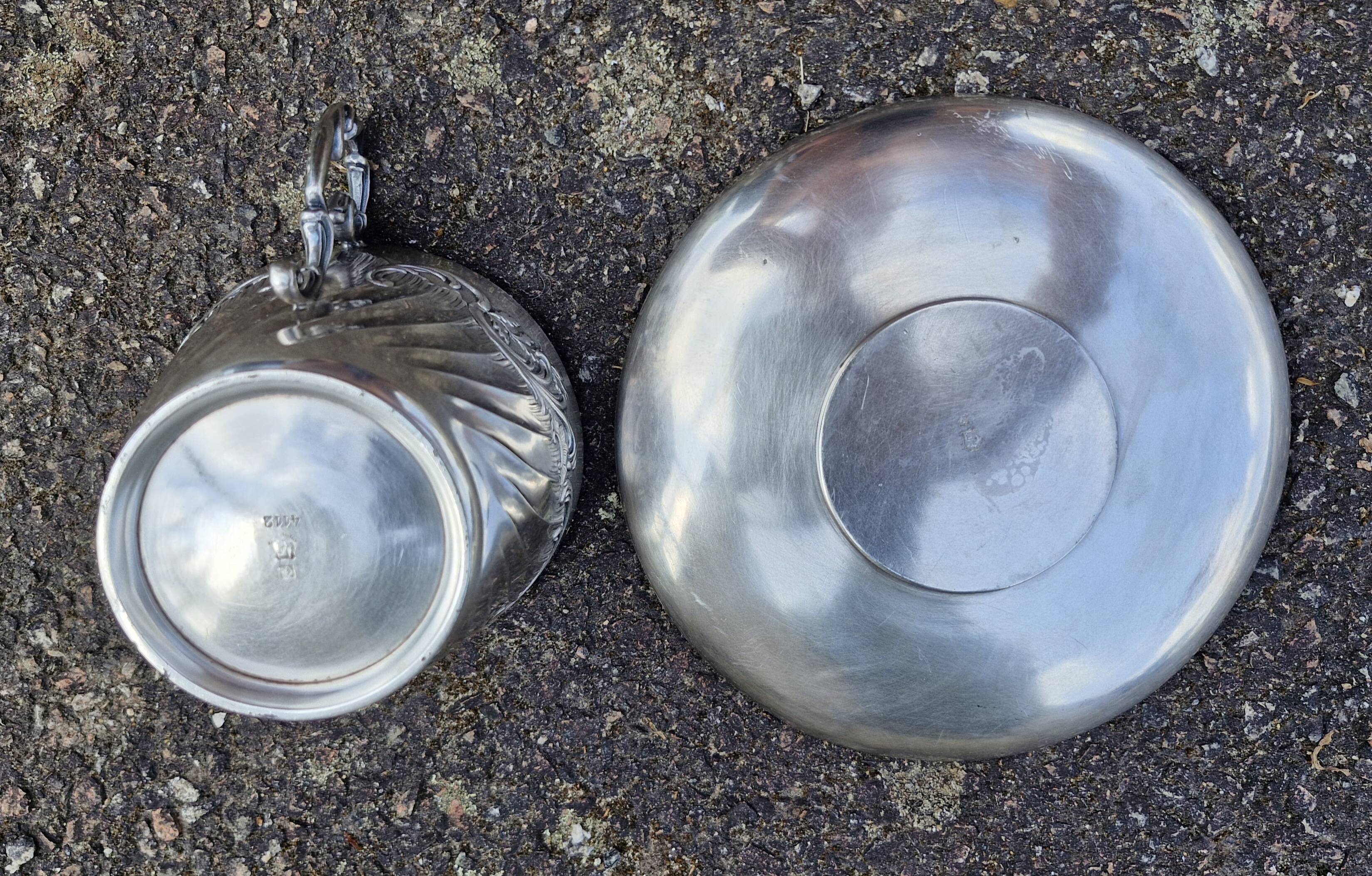 Cup and saucer in solid silver.