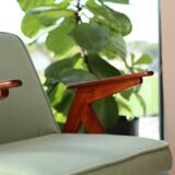 Vintage armchair in mint green wool, mid-century modern design.