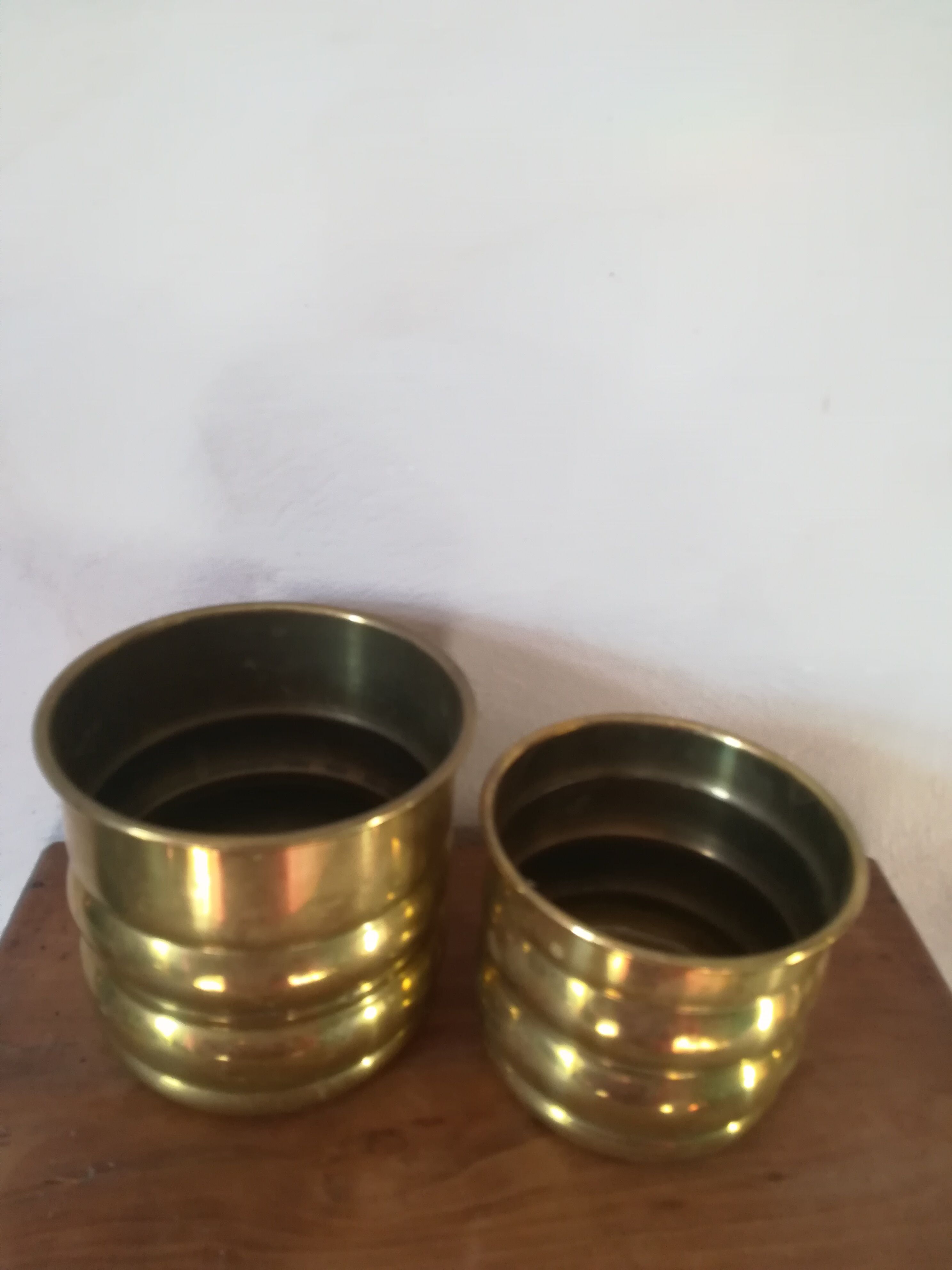 Duo of brass pot covers