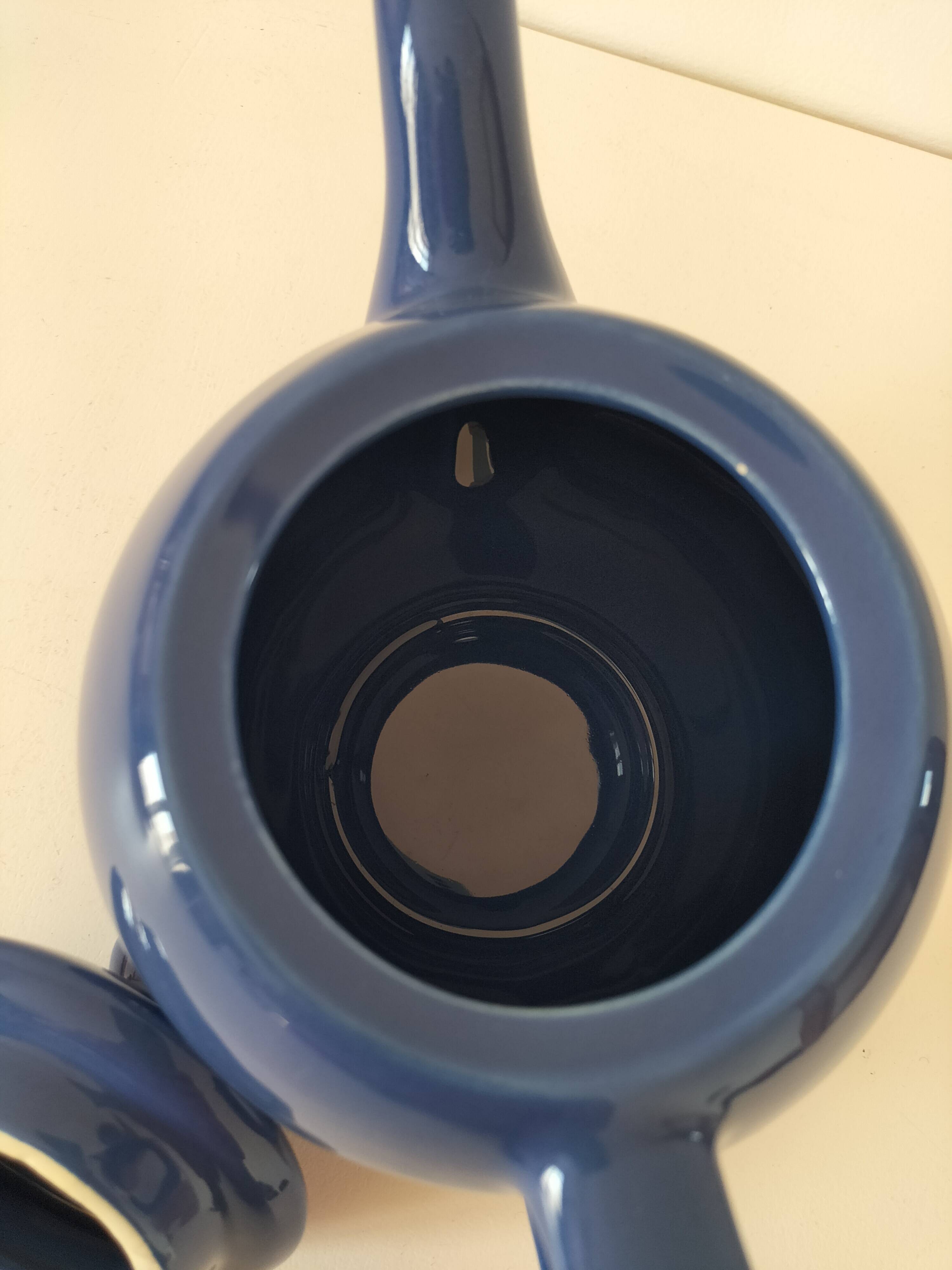 Vintage deep blue teapot, minimalist round shape.