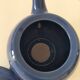 Vintage deep blue teapot, minimalist round shape.