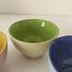 Set of three pastel two-tone mini bowls in glazed ceramic.