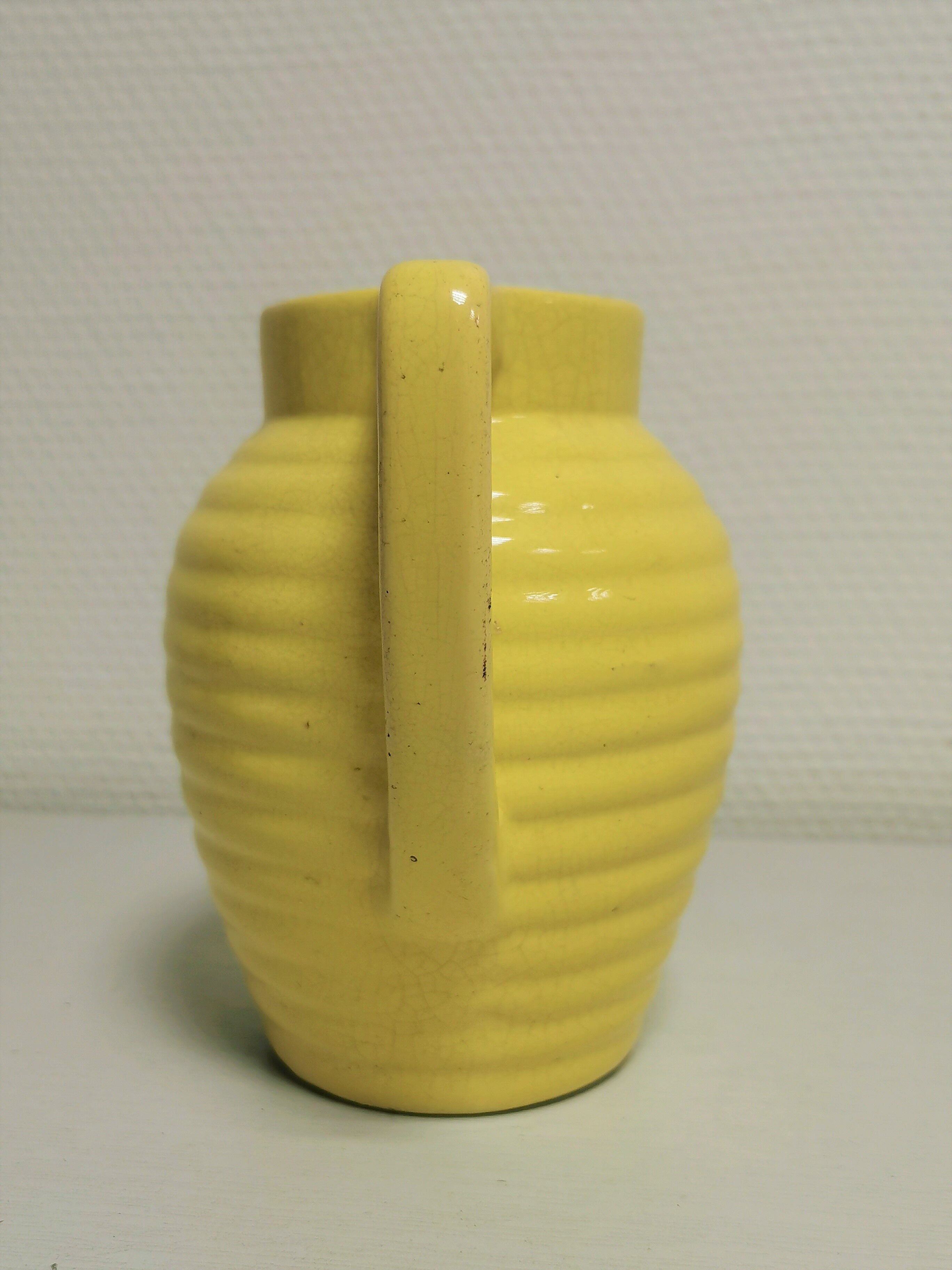 Yellow pitcher in slurry, faience onnaing frères
