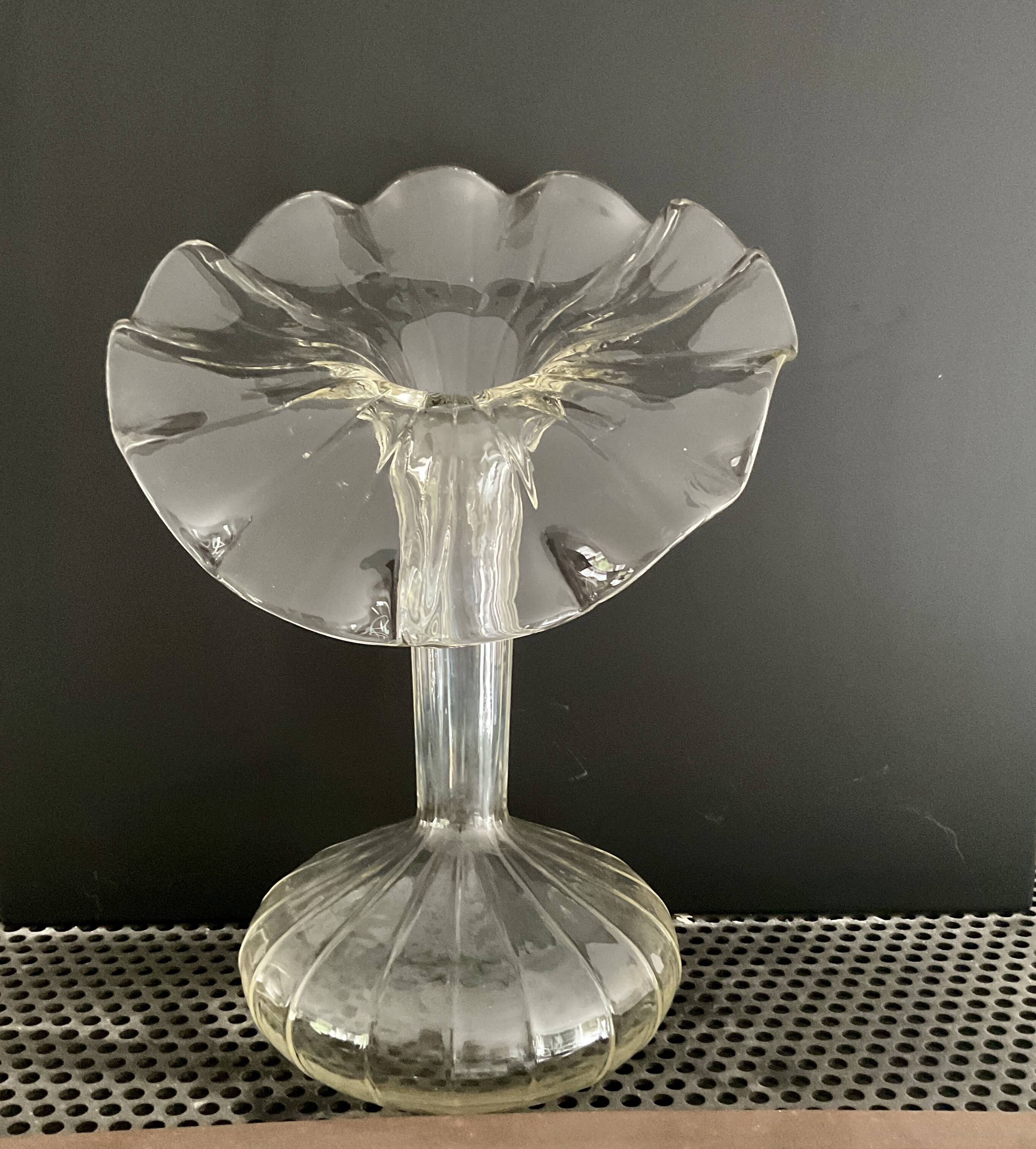 Vintage transparent glass vase in flower shape.