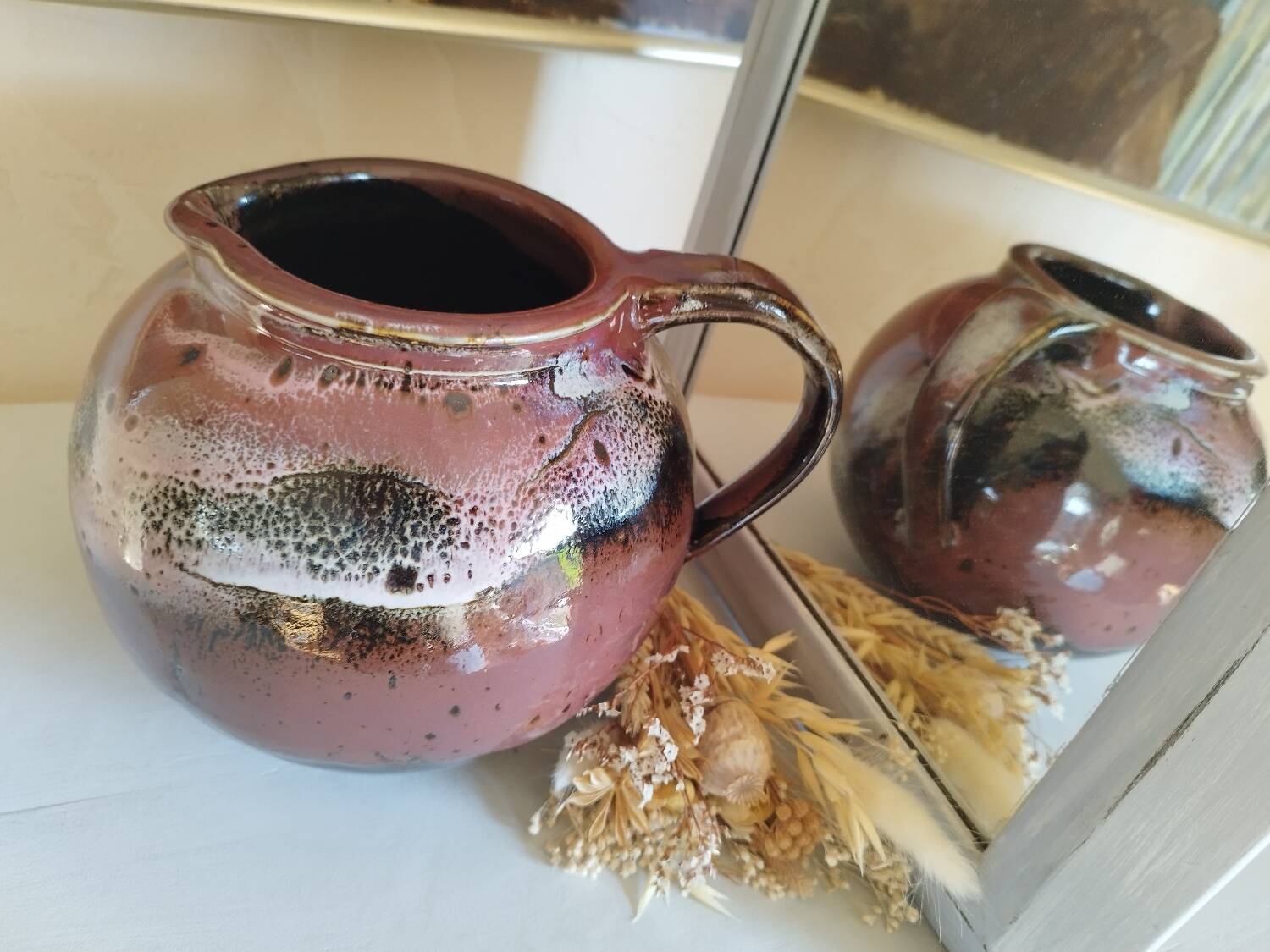 Stoneware pitcher by Matthieu Liévois in shades of red