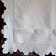 scalloped pillowcase decorated with a baron's crown