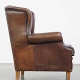 Wing chair made of sheepskin and neatly finished with black piping
