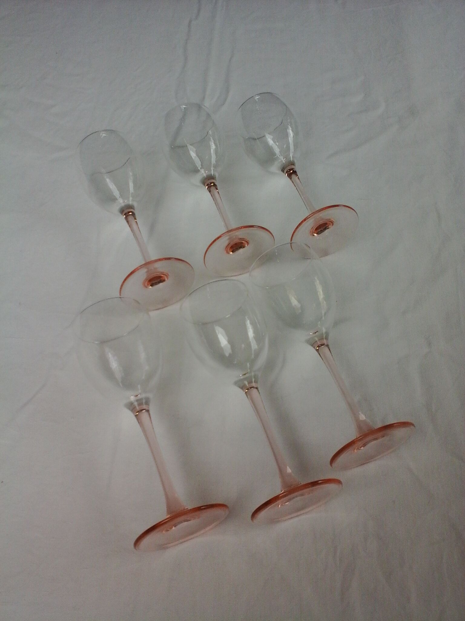 6 glasss of wine on pink foot