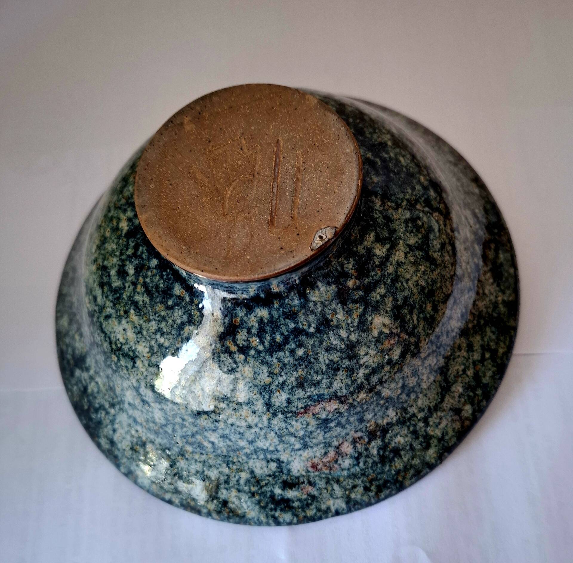 Bowl on a circular base or small blue ceramic dish.