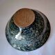 Bowl on a circular base or small blue ceramic dish.