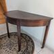Old half-moon table or serving trolley on wheels
